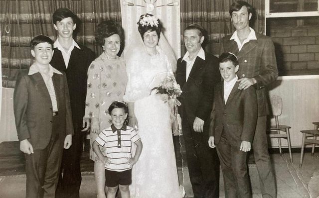 Black-and-white wedding photo: YoungPa and YoungMa with their sons around a bride.