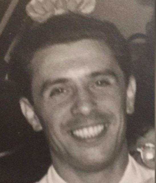 Black-and-white close-up of YoungPa as a young man, smiling.