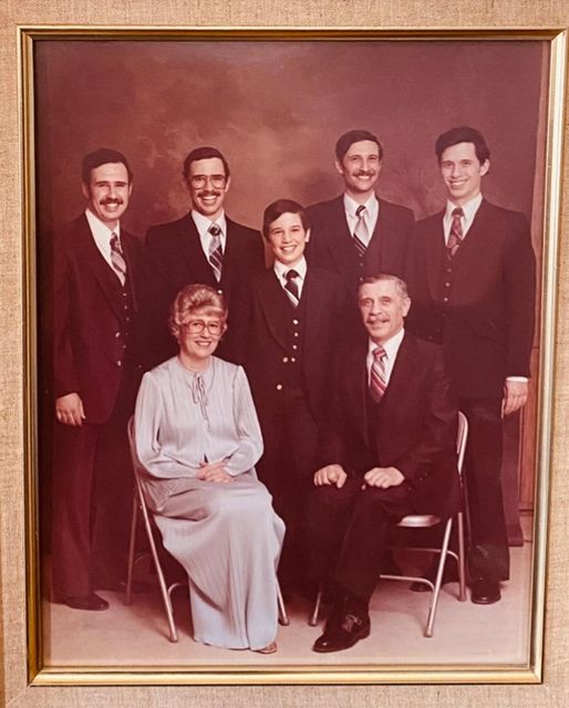 Formal studio portrait: YoungPa and YoungMa seated, their five sons standing behind and beside them.